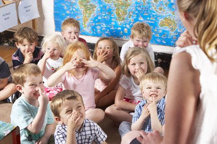 Montessori/pre school class listening to teacher on carpet